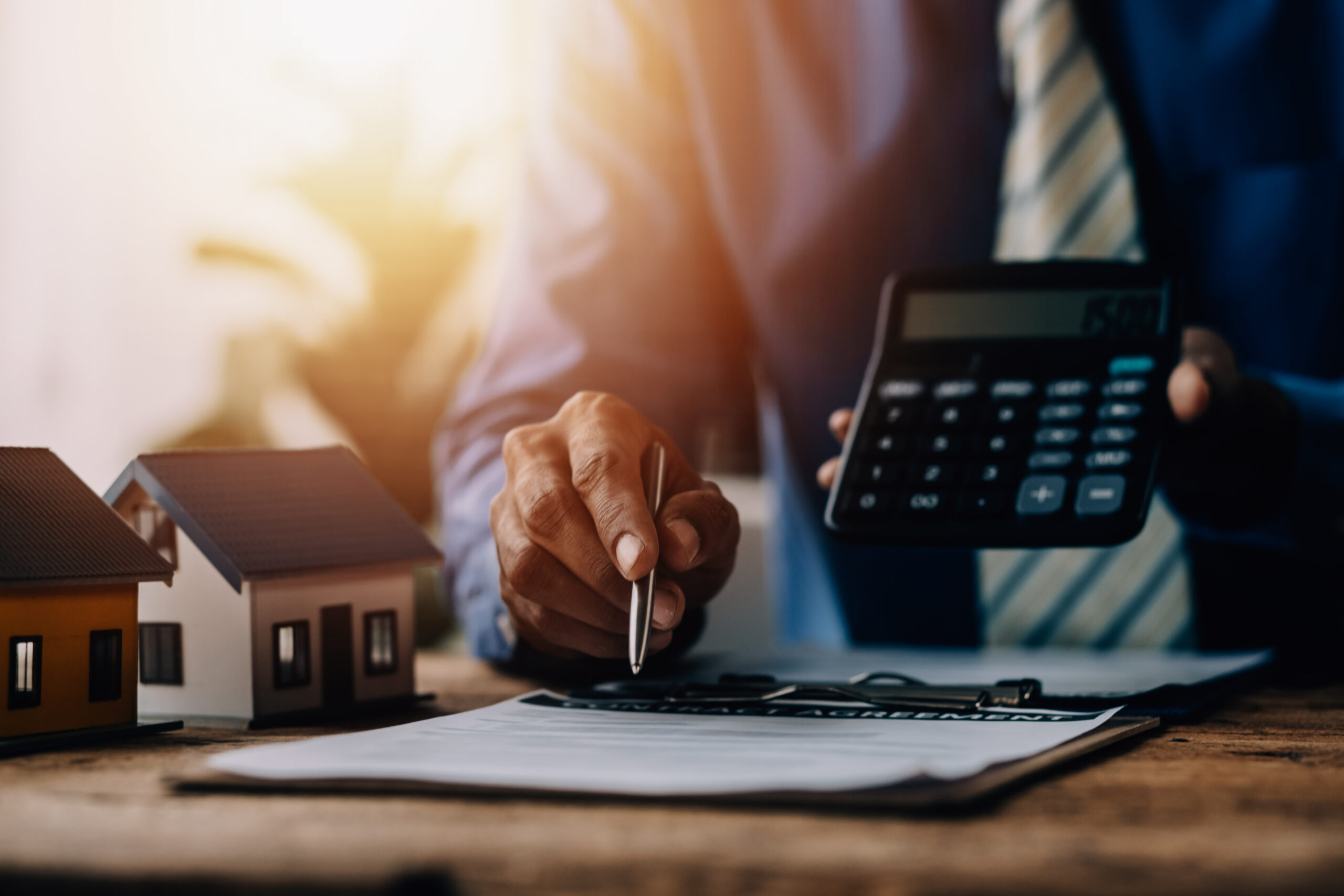 Real estate broker agent presenting and consult to customer to decision making sign insurance form agreement, buy and sell home model, concerning mortgage loan offer for and house insurance