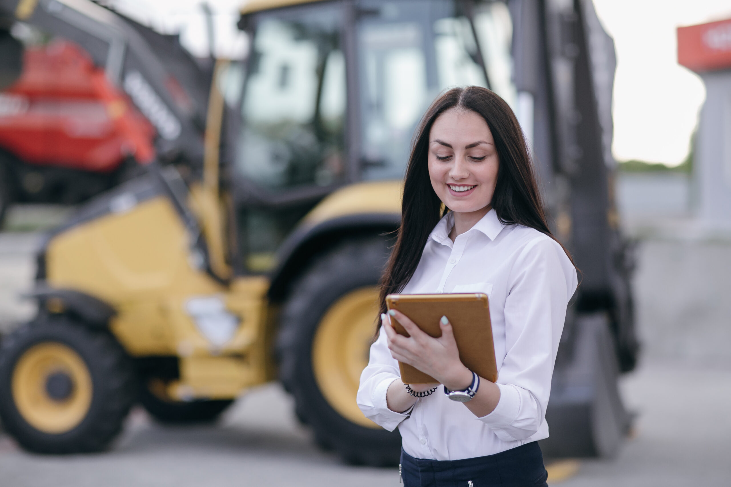 working-woman-smiling-with-orange-tablet-hands
